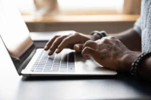 A close up of typing hands for Unity Counseling. Learn more about online therapy in Michigan and other services including online anxiety treatment in Kent County, CA. An online therapist in Michigan can offer support.