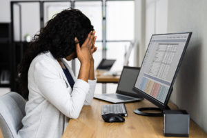 A woman appears upset while sitting at her laptop. An anxiety therapist in Grand Rapids, MI can help address symptoms of perfectionism. Learn more about depression treatment in Kent County, MI and other services by searching "anxiety treatment in Grand Rapids, MI" today.
