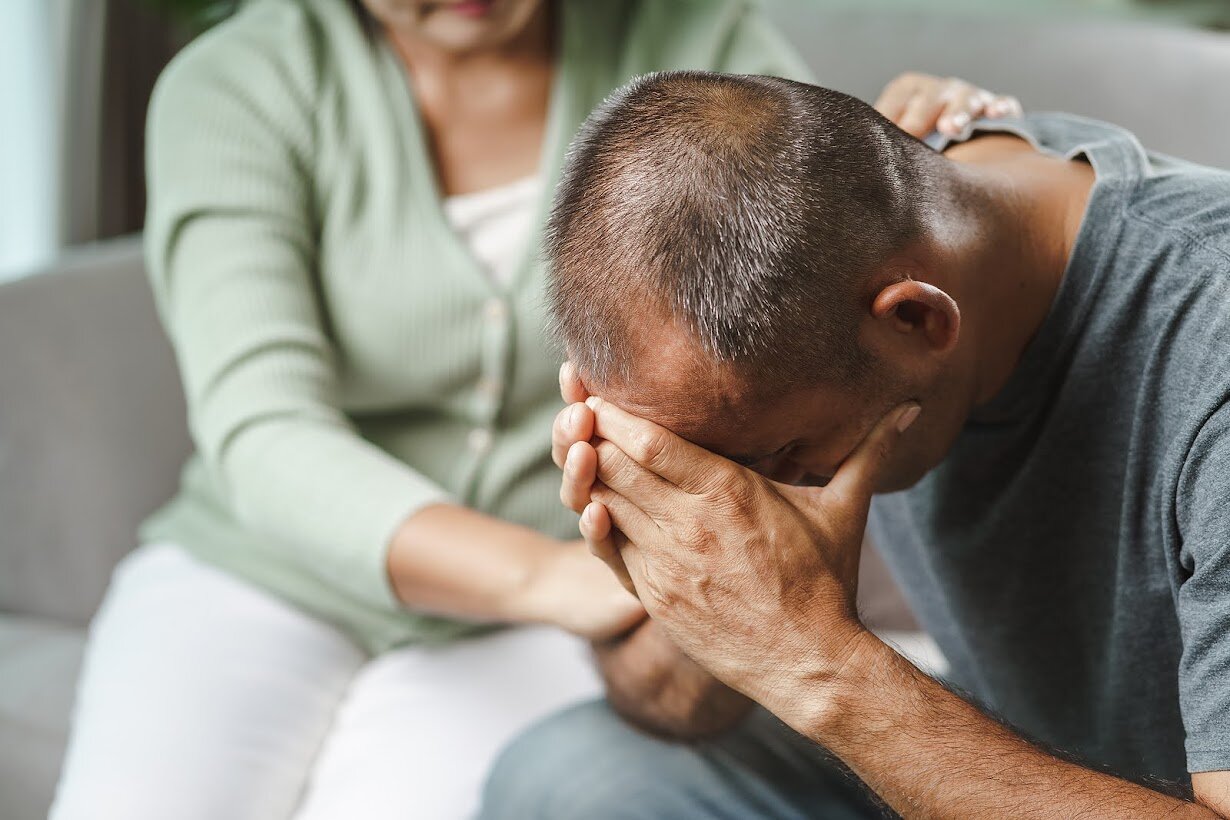 Woman comforting man | If you're looking to find ways to support your partner, read this blog and reach out to depression therapists in kent county. Online Therapy in MI can help your depression symptoms.